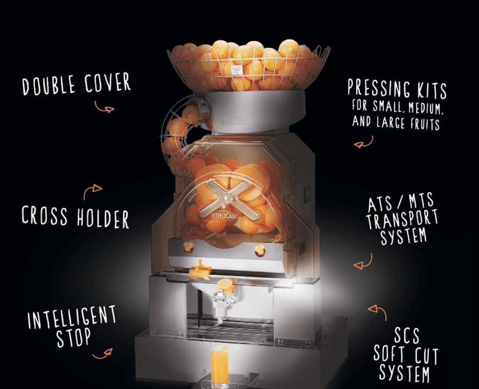 An industrial commercial citrus juicer machine filled with oranges. Key features labeled around the machine include 'Double Cover,' 'Cross Holder,' 'Intelligent Stop,' 'Pressing Kits for Small, Medium, and Large Fruits,' 'ATS/MTS Transport System,' and 'SCS Soft Cut System.'